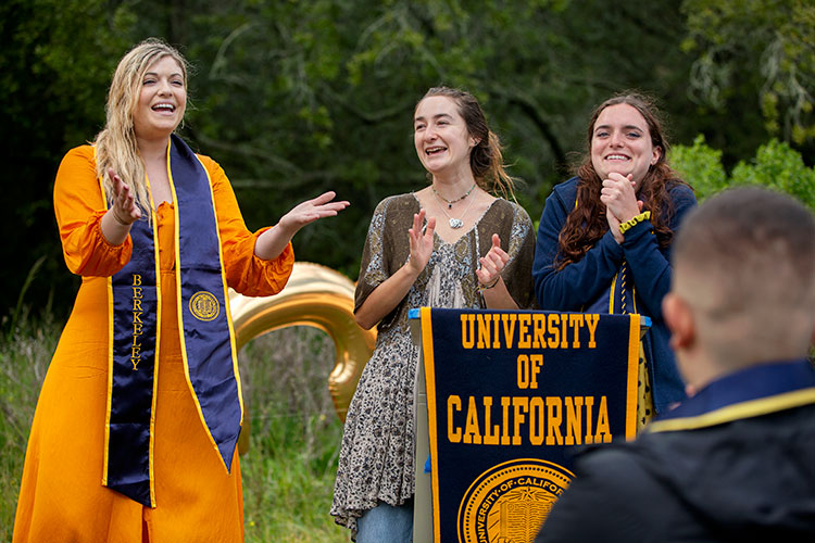 Tanya Hanson (left), Skye Michel and Leah Jones stand at a pedestal at the CRS alternative graduation ceremony