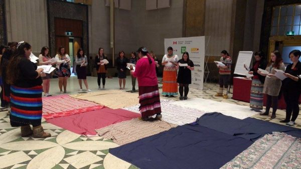 group of people standing around blankets