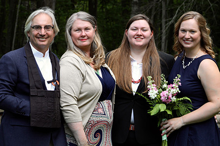 four people standing