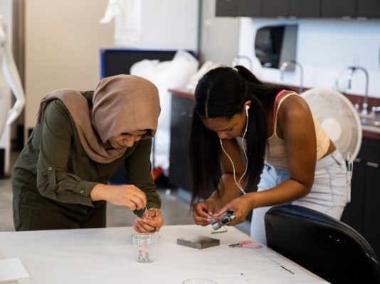 two women working on making jewlery