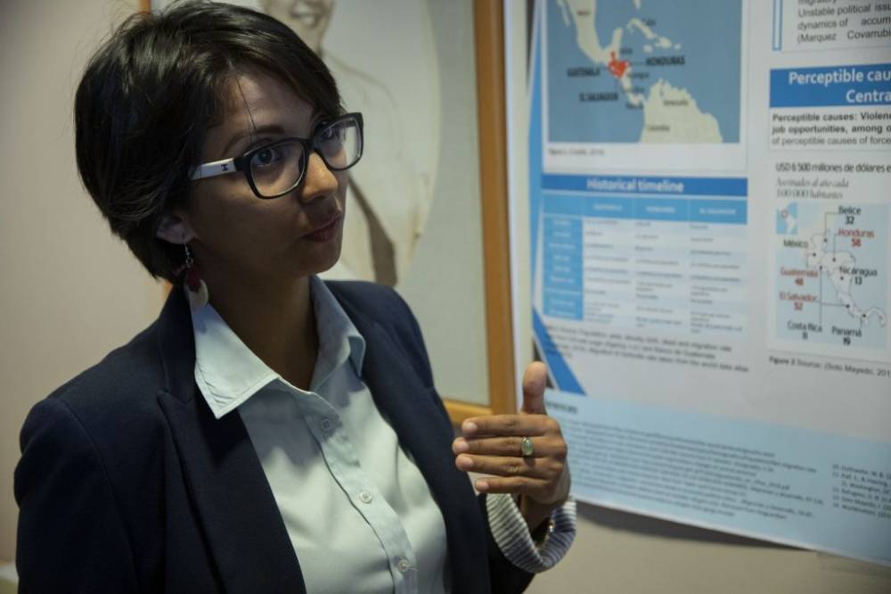 woman standing in front of poster