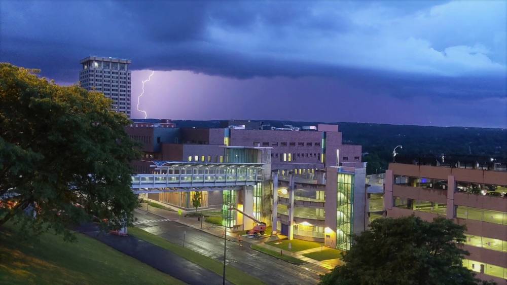 dark clouds and lightning strike over Dineen Hall