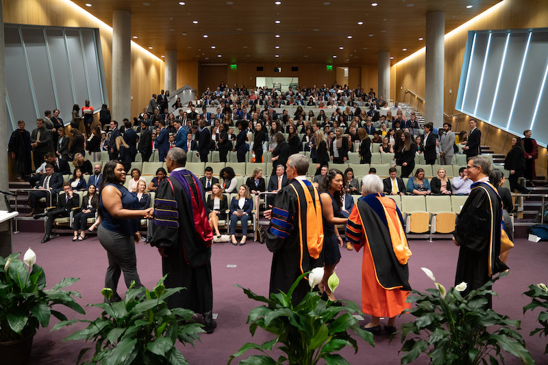 people shaking hands in auditorium