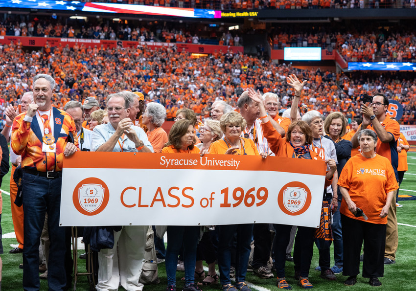 group of people holding a banner