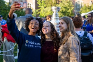 Students take selfies with the Stanley Cup during the celebration of Chancellor Martin's inauguration Oct. 3. (Photo: Devon Hill/Washington University)