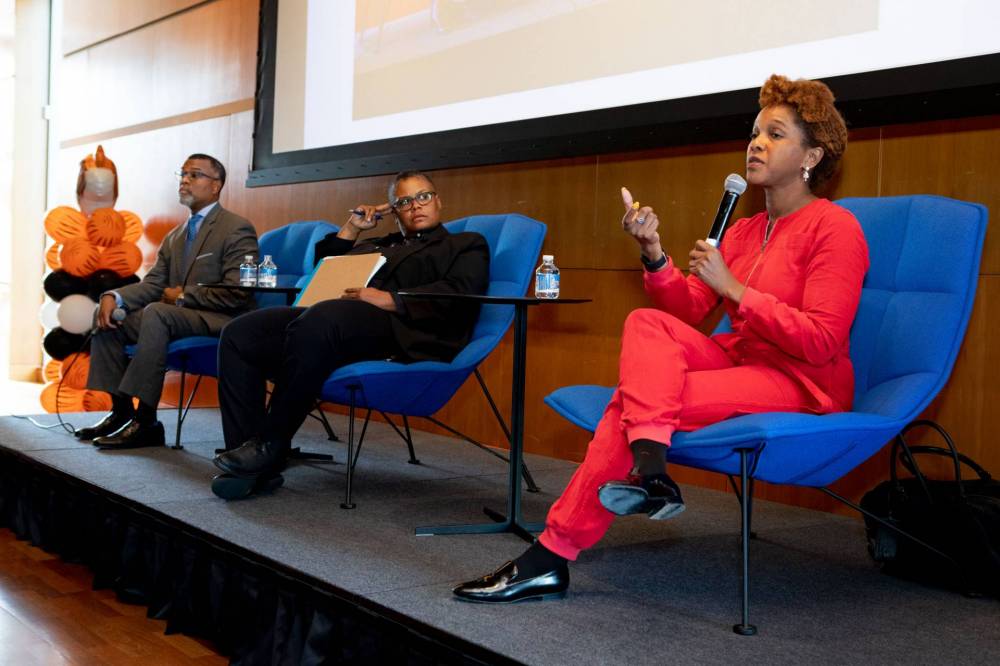 Panelists speaking on stage