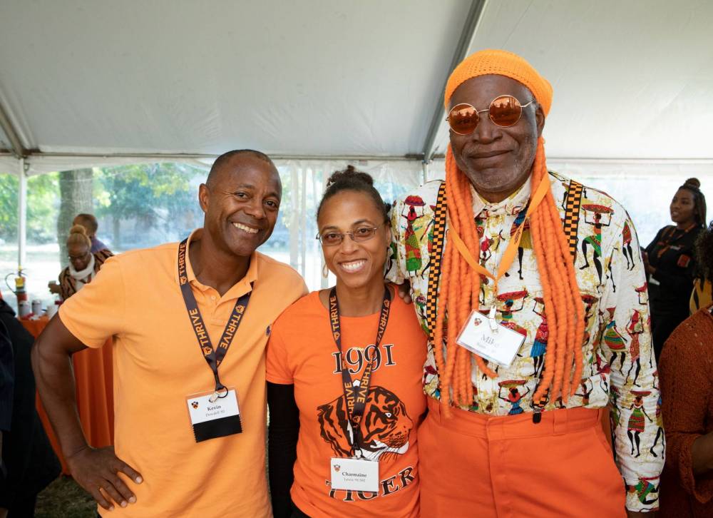 Three alumni posing for a photo