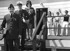 Military personnel standing with books