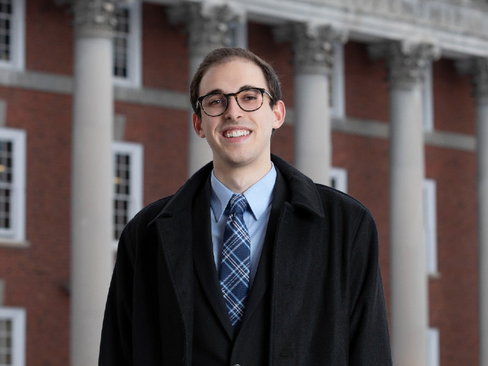 man standing in front of Maxwell Hall