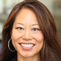 Woman with brown hair smiling at the camera