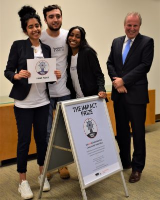 students pose with competition winnings