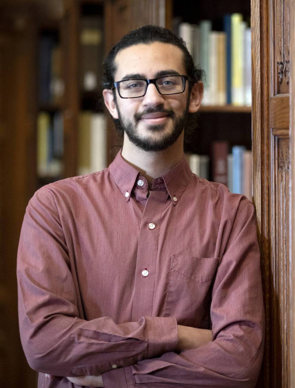 Yousef Elzalabany standing in a library