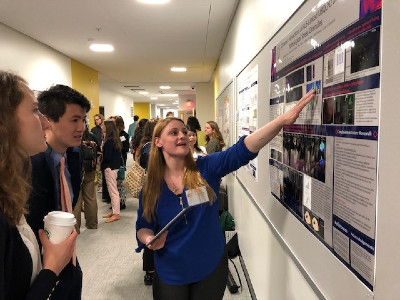 woman pointing to a poster