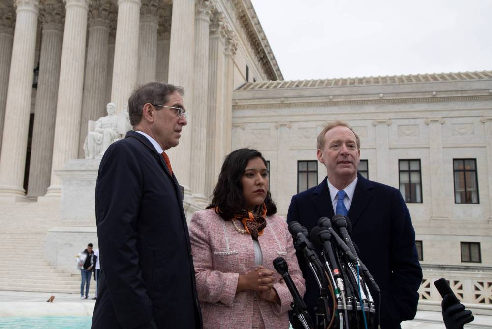 Christopher Eisgruber, Brad Smith and Maria Perales Sánchez on the steps of the Supreme Court building in Washington, D.C.