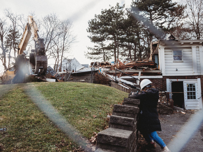 woman taking video of demolition