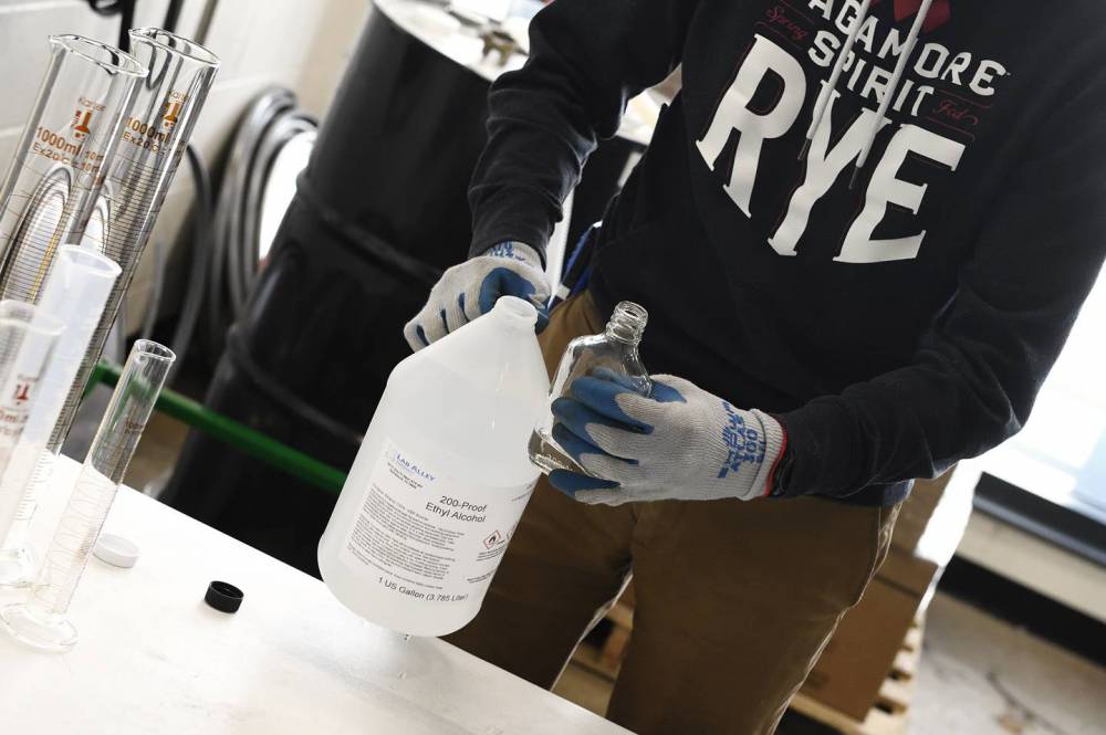 Norwood pours a sample of the ethyl alcohol provided by Johns Hopkins.