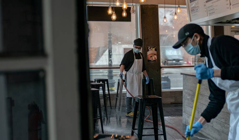 Restaurant staff clean the floor after closing early afternoon following the outbreak of coronavirus disease (COVID-19), in New York City, U.S., March 16, 2020. Credit: REUTERS/Jeenah Moon