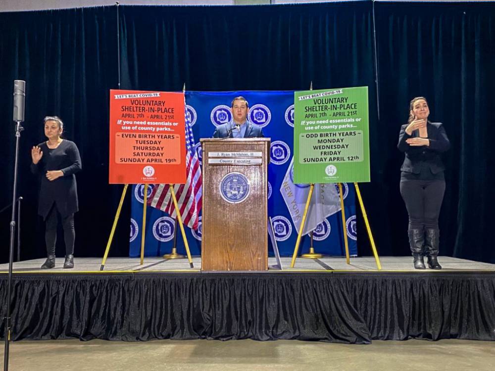 Covid-19 press conference featuring Onondaga County Executive Ryan McMahon, with American Sign Language interpreters on either side.