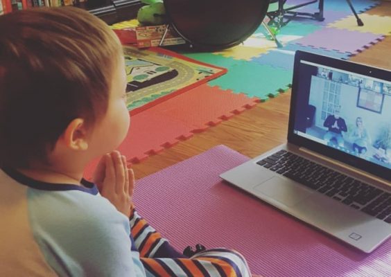 a child watching an online yoga video