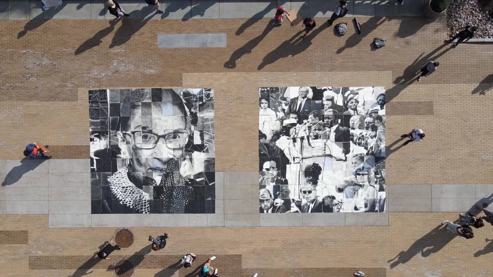 students surround a mosaic of drawings on the Einhorn Family Walk