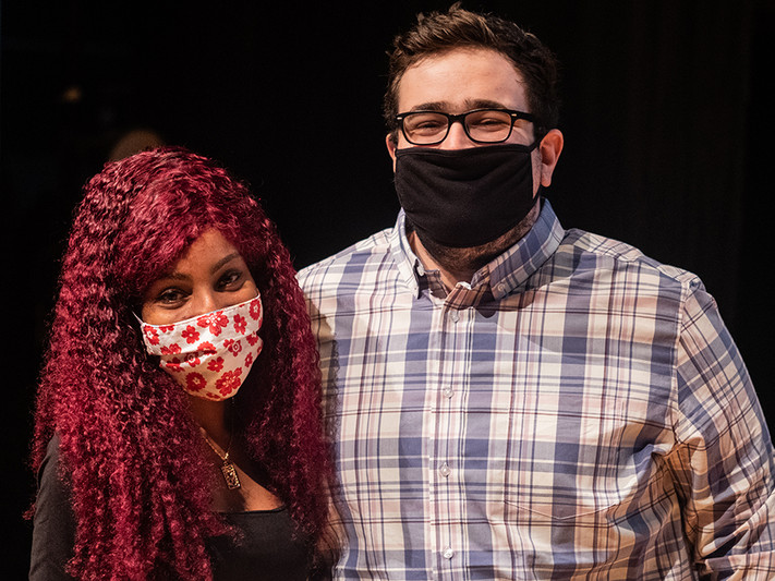 two people wearing masks