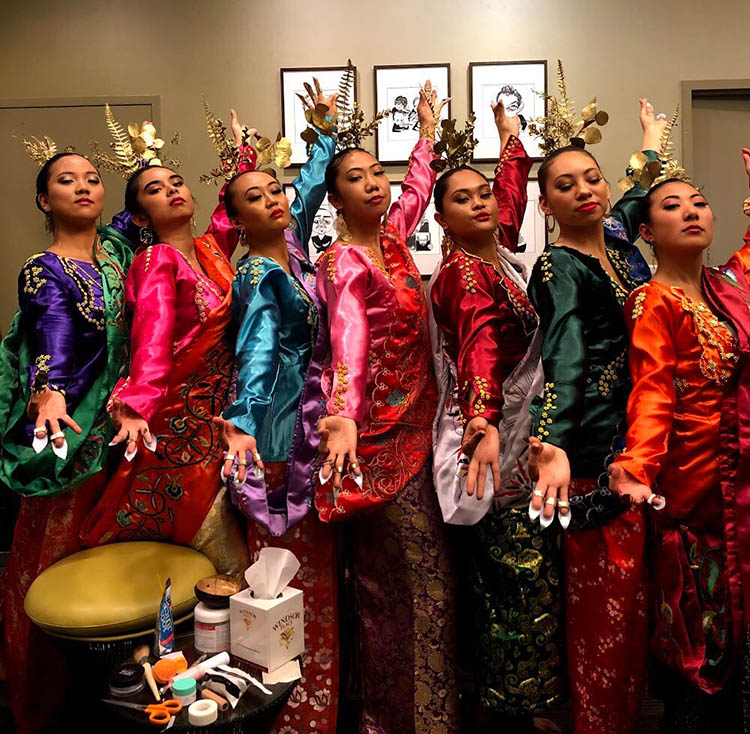 Katalina Cortezt poses in traditional cultural dance attire with dance group